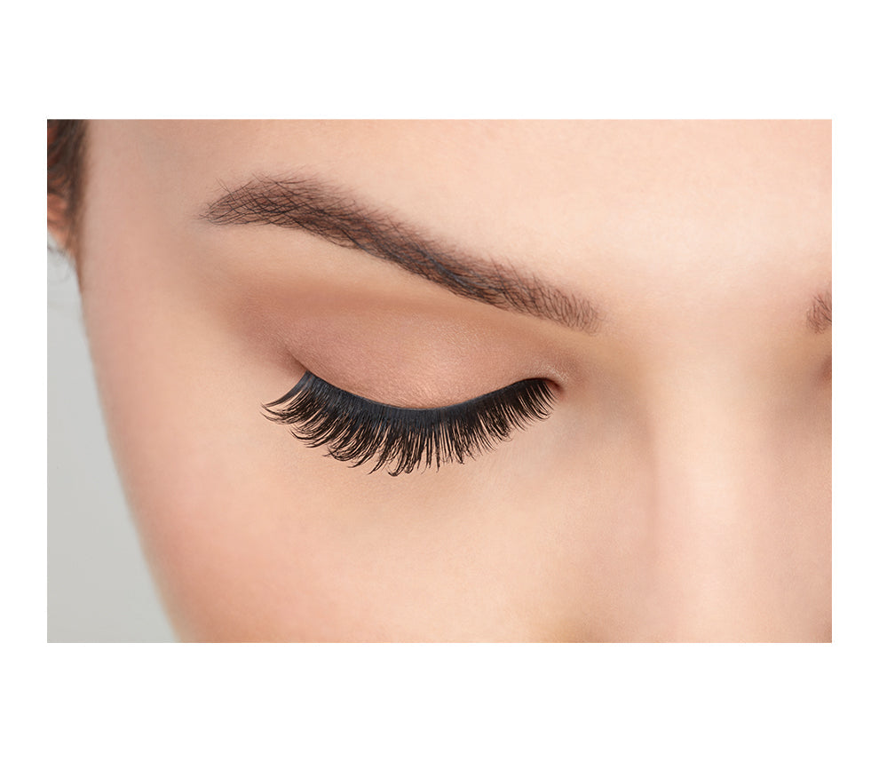 Close-up of a model's closed right eye wearing an Ardell Faux Mink 810 false lash