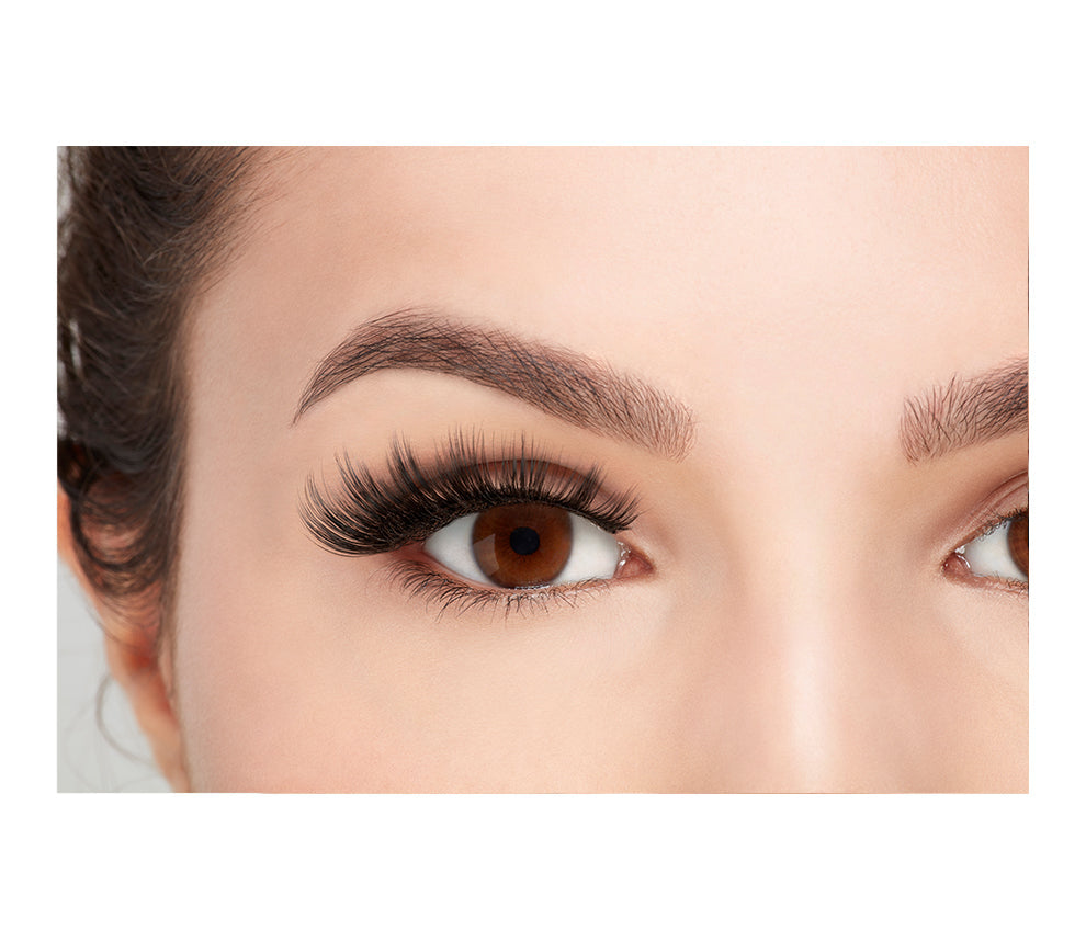 A model wearing Ardell's Faux mink 852 with close right eye showing its total volume & long length, flared, winged-out lash