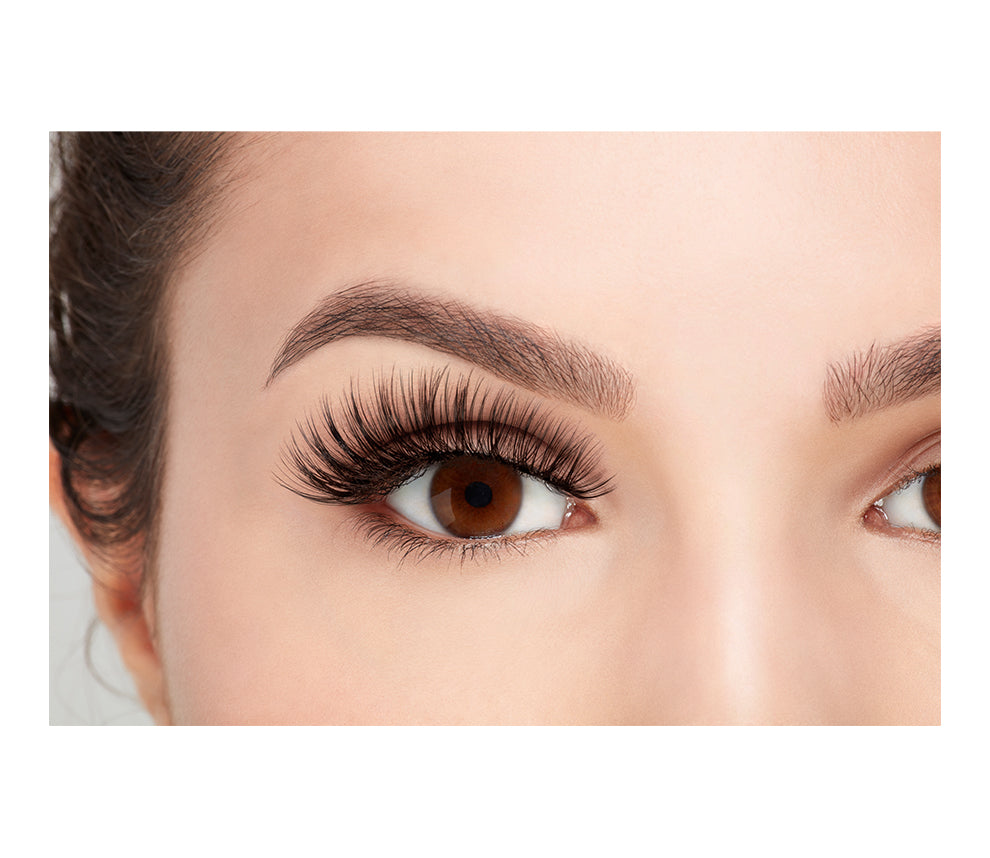 A model with open eyes wearing the Ardell 3D Faux Mink 853 eyelash in a front view photo