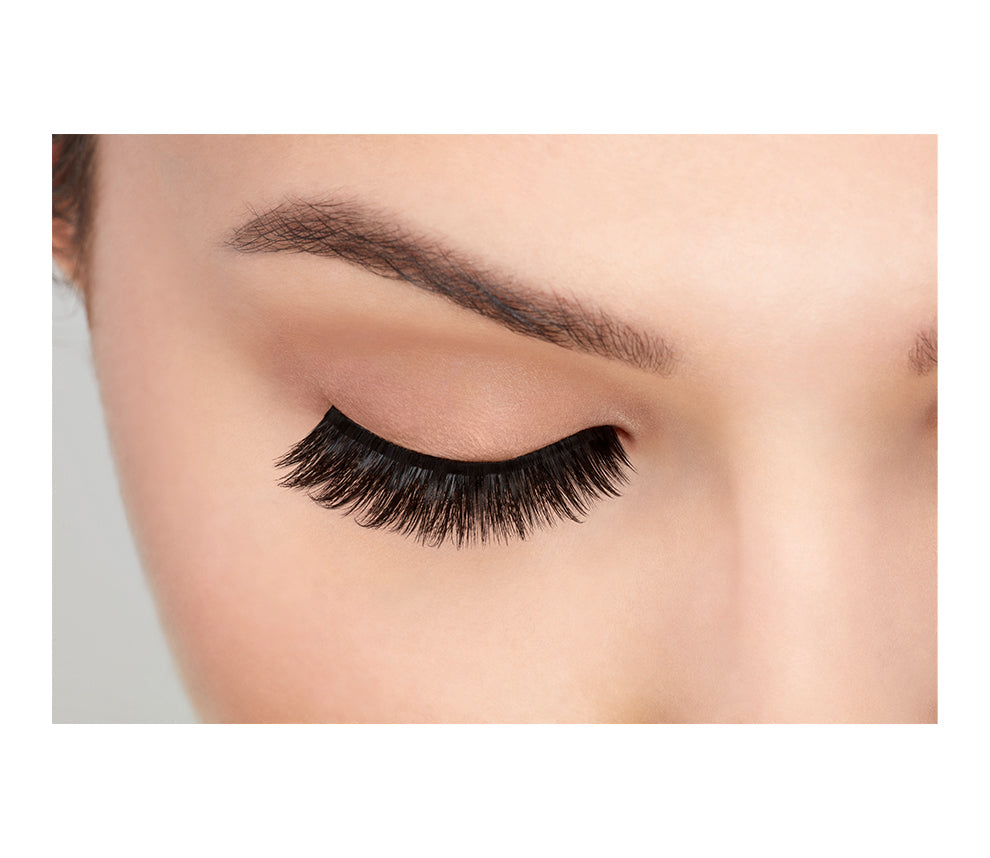 A model with a closed eye wearing the Ardell 3D Faux Mink 854 eyelash showing how it looks like when worn on a frontal view.