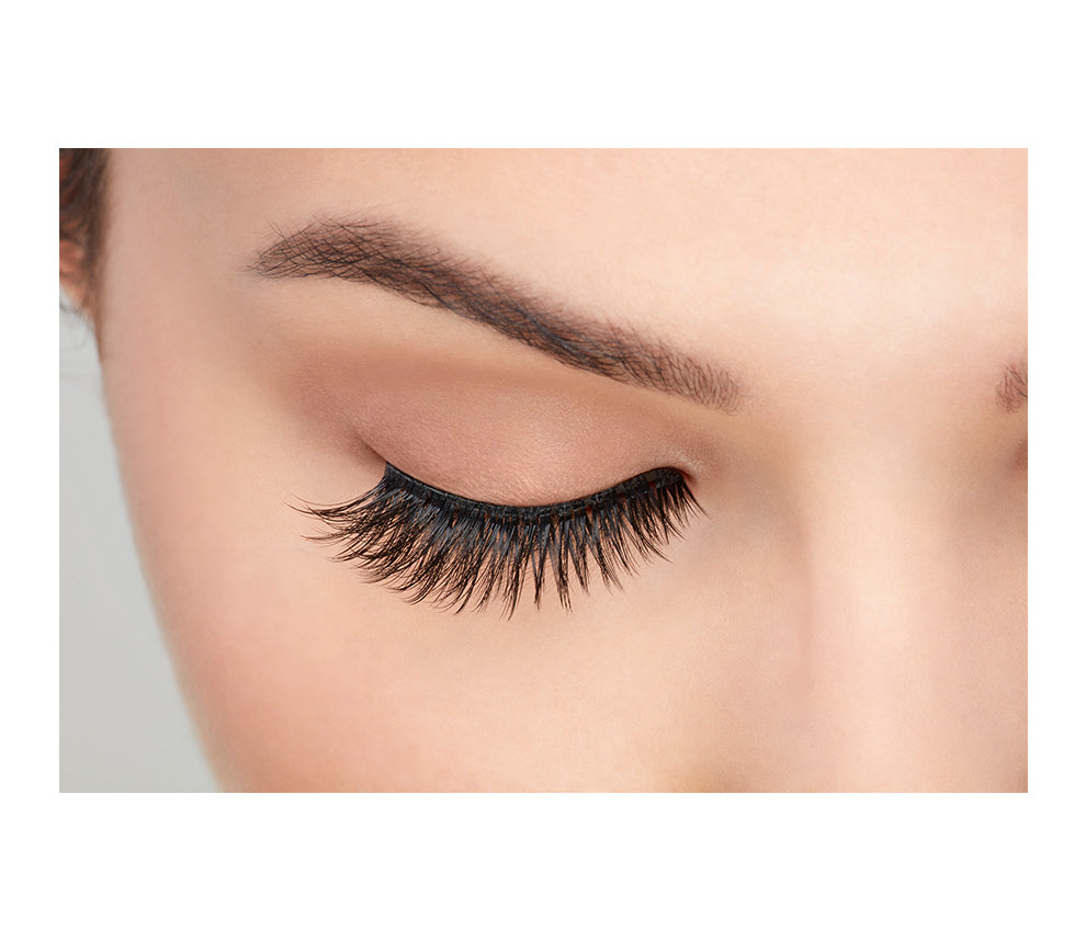 The Ardell's 3D Faux Mink 857 eyelash on a model with closed eyes showing how the lashes look when worn from a front-on view
