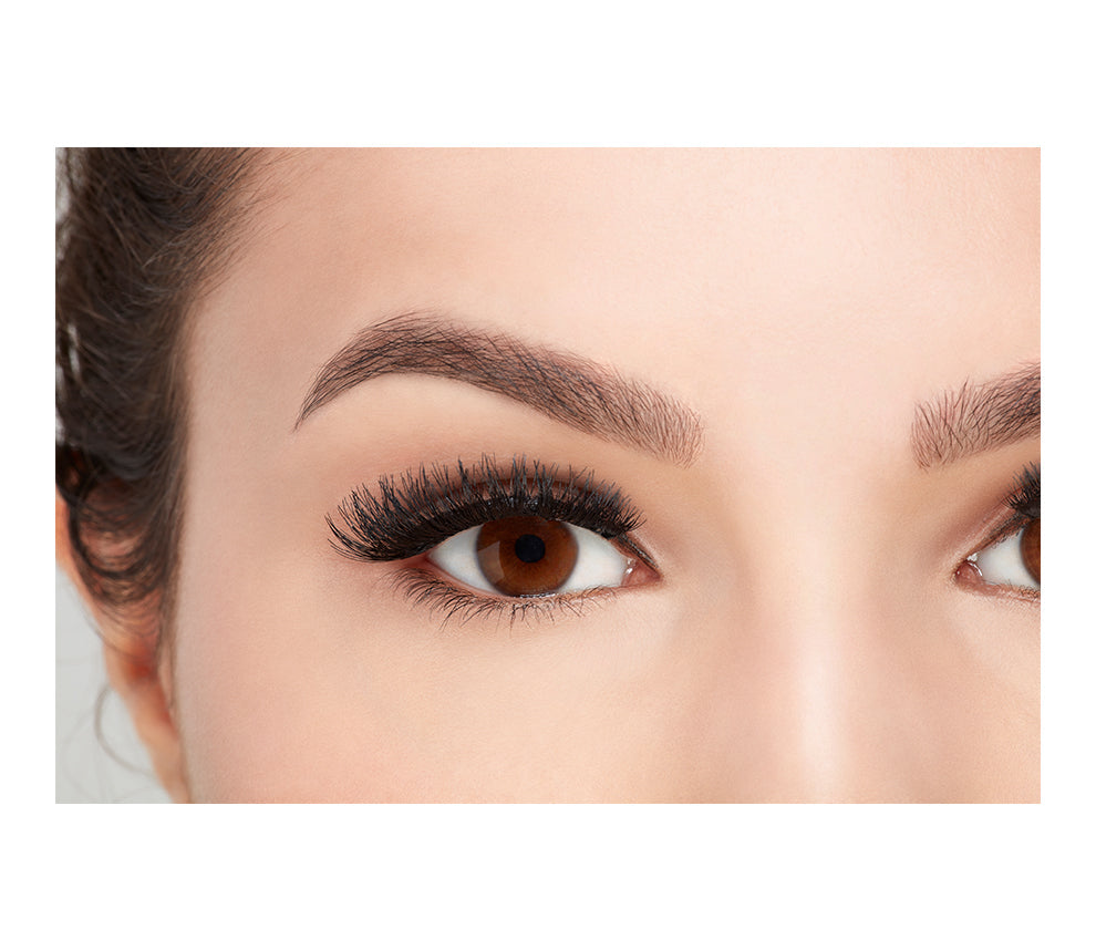 Close-up of a model's open right eye wearing an Ardell Magnetic Double Demi Wispies upper faux lash