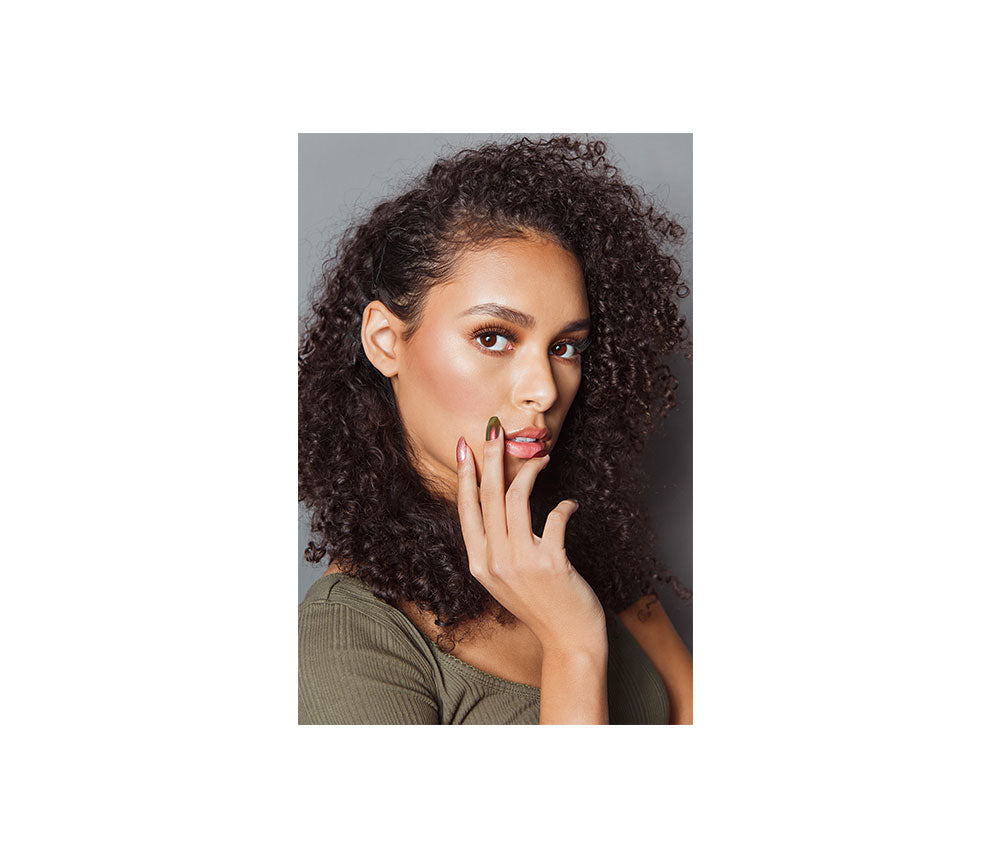 a woman with a glare look and her two fingers in her cheek showing Ardell Nail Addict Artificial Nail-Red Cateye variant