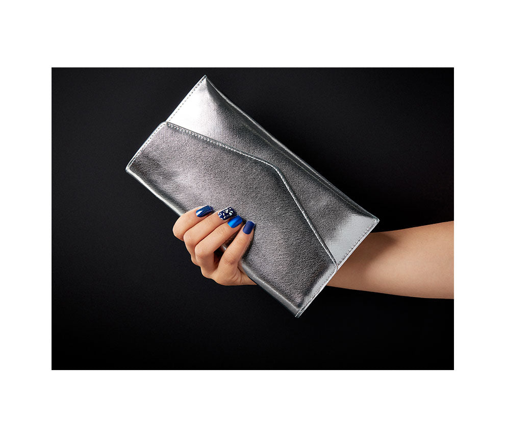 a woman hand holding a silver pouch showcasing her fingernails with Ardell Nail Addict Artificial Nail - Matte Blue variant