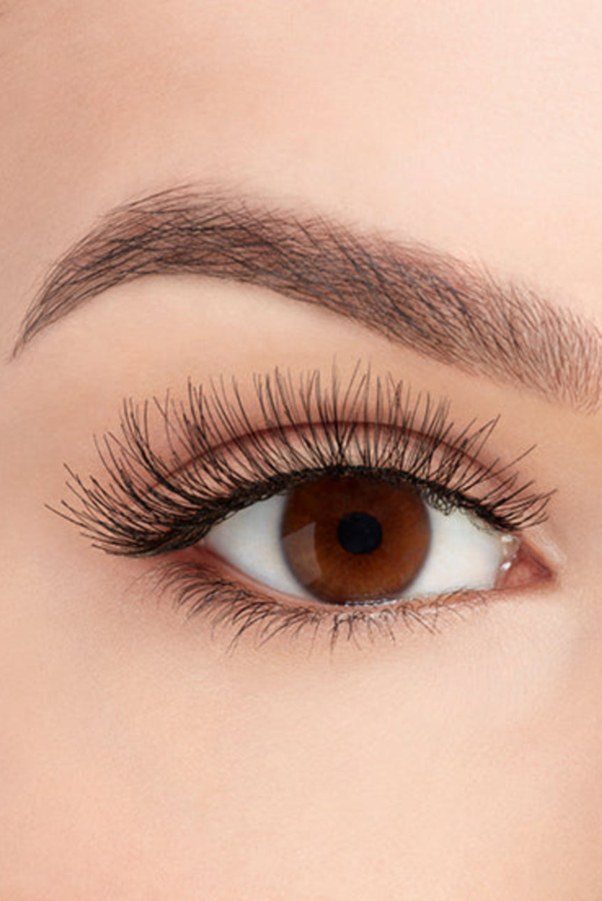 A model with an open right eye wearing Ardell Demi Wispies showing how it looks like when it's worn