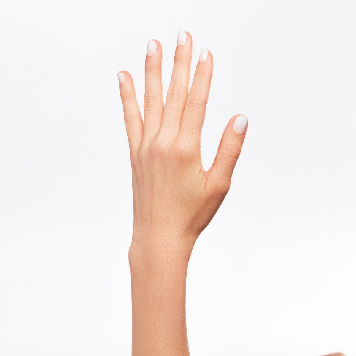 A hand of a lady with nail color.