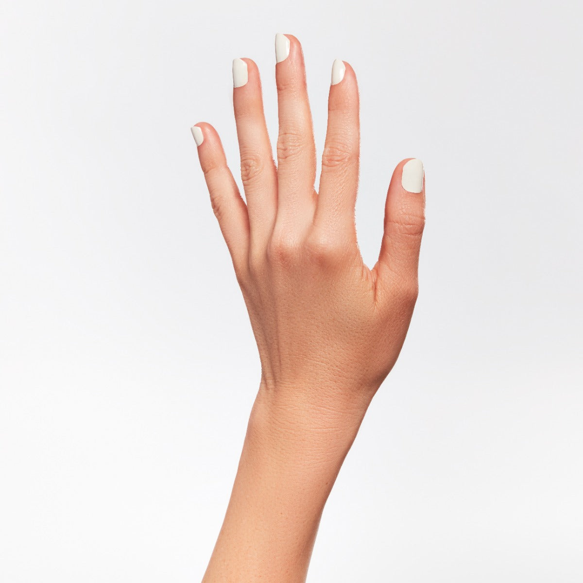 A hand of a lady with nail color.