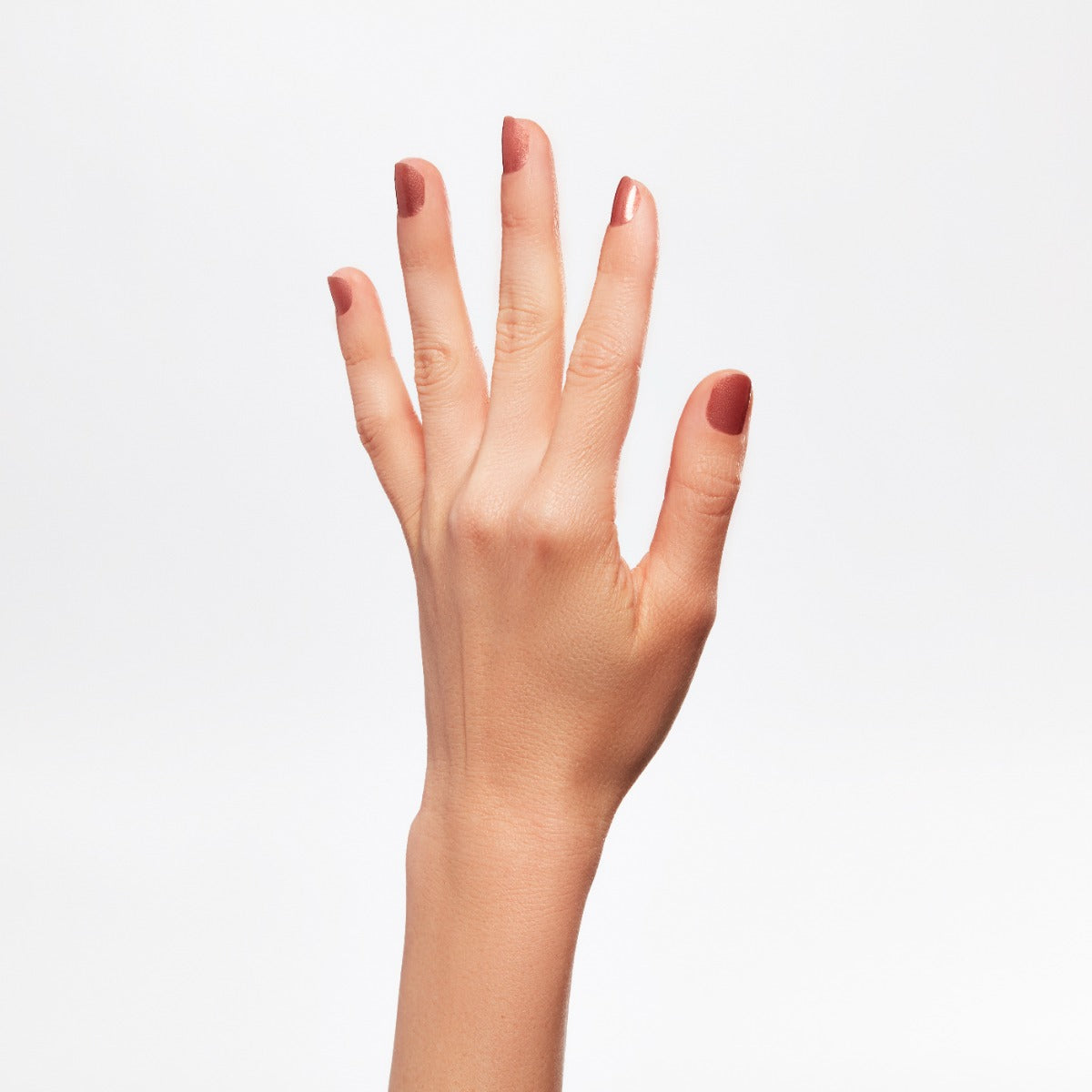 A hand of a lady with nail color.
