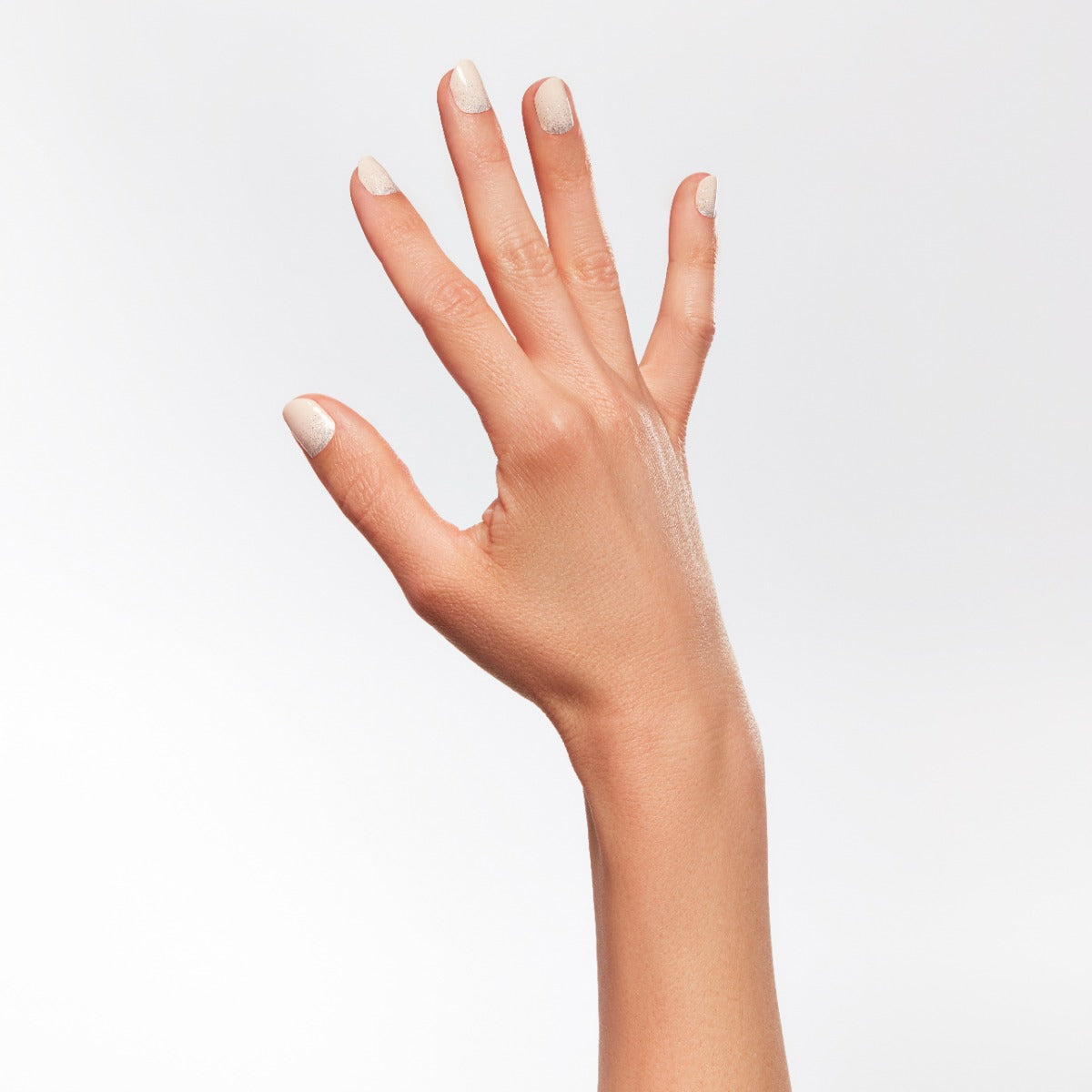 A hand of a lady wearing a nail lacquer.