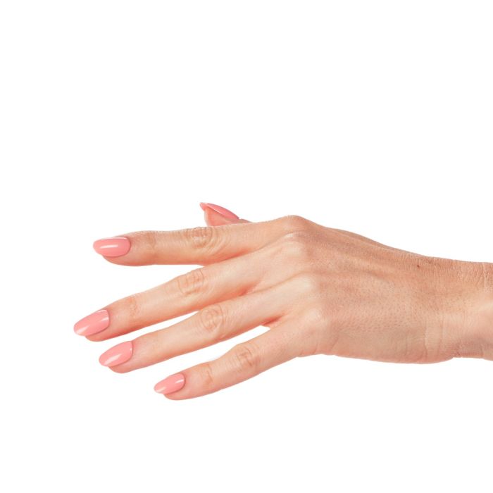 Natural hand pose featuring Peachy Pink gel polish, a delicate and cheerful coral-pink shade.