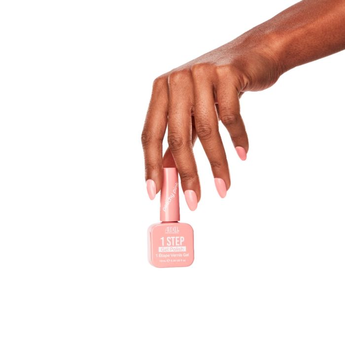 Model hand with glossy Peachy Pink gel polish, a soft coral-pink shade from Ardell 1 Step Gel collection.