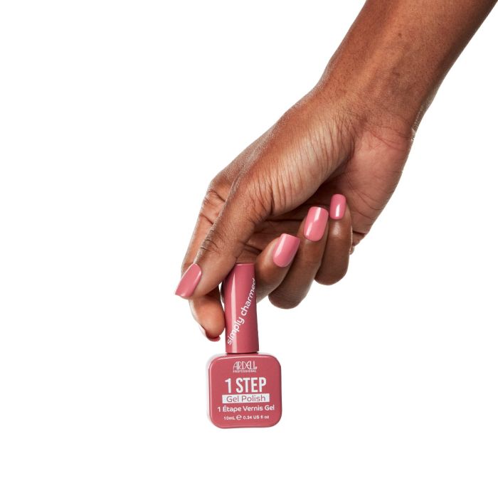 Model hand with neatly polished nails in Simply Charmed rosy pink gel polish by Ardell.