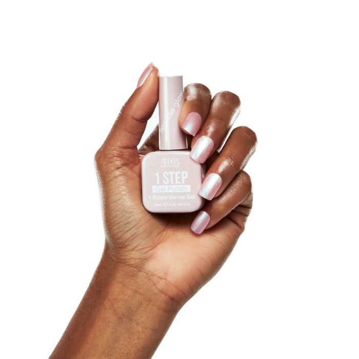 Model hand with soft pink shimmer manicure holding Ardell 1 Step Gel Polish in Lipgloss Glow.
