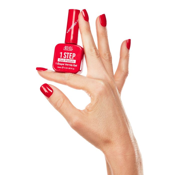 Close-up hand shot with Ardell Venetian Red polish, a bold yet elegant crimson hue in a crème formula.