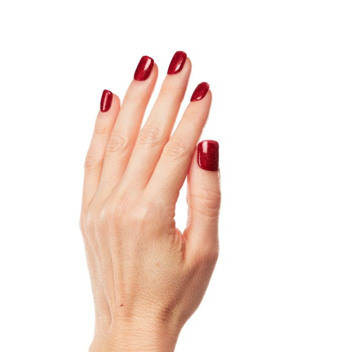 Close-up of hand wearing Ardell Lusty polish, a bold red with fine shimmer for a show-stopping nail look.