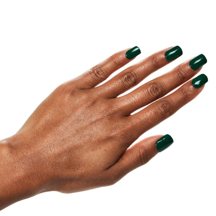 Close-up hand pose featuring Ardell Privileged gel polish, highlighting its elegant deep green finish.