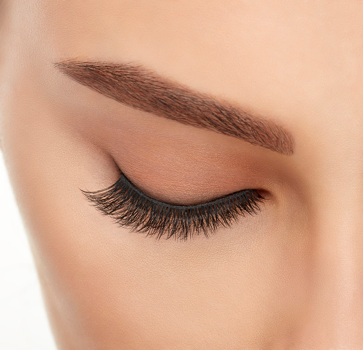 Close-up of a model's closed right eye wearing an Ardell Lift Effect 741 faux lash