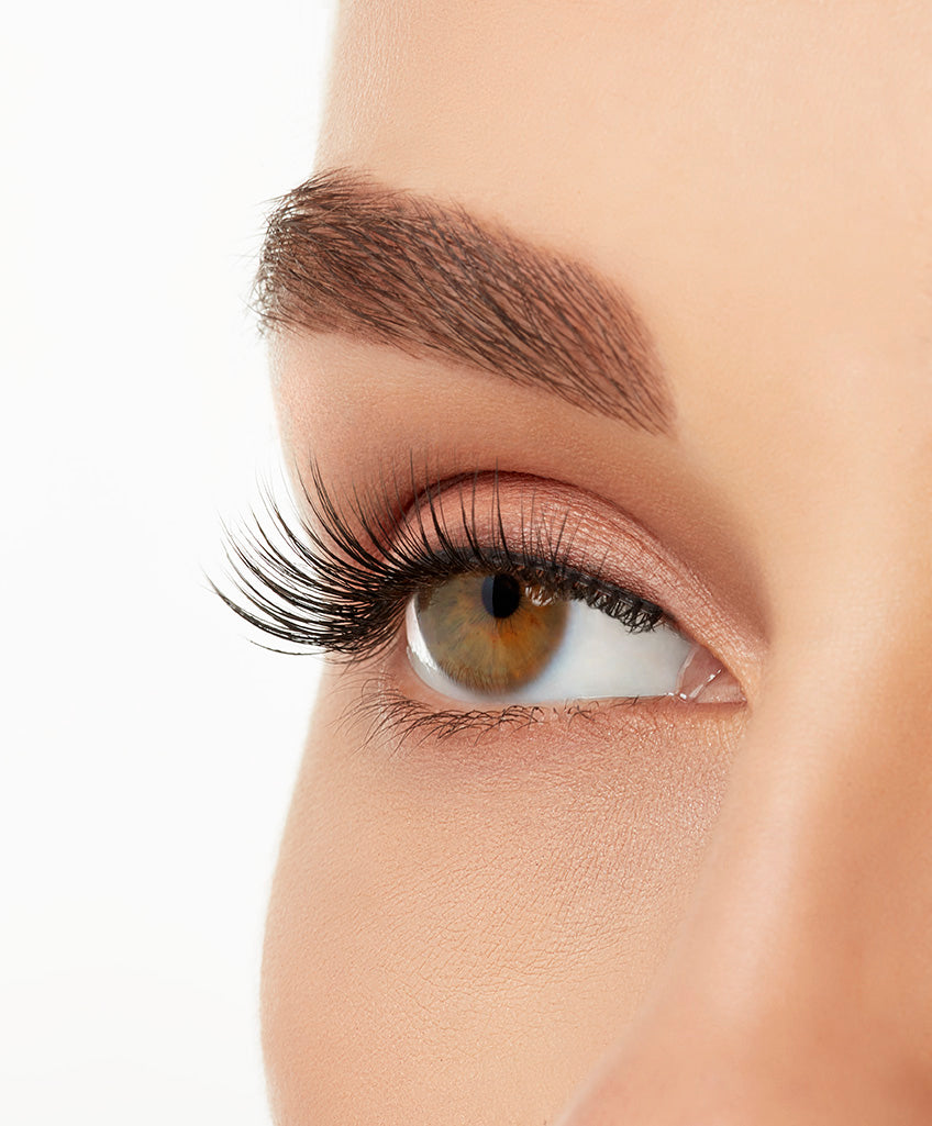 Angled close-up of a model's open right eye wearing an Ardell Lift Effect 744 faux lash