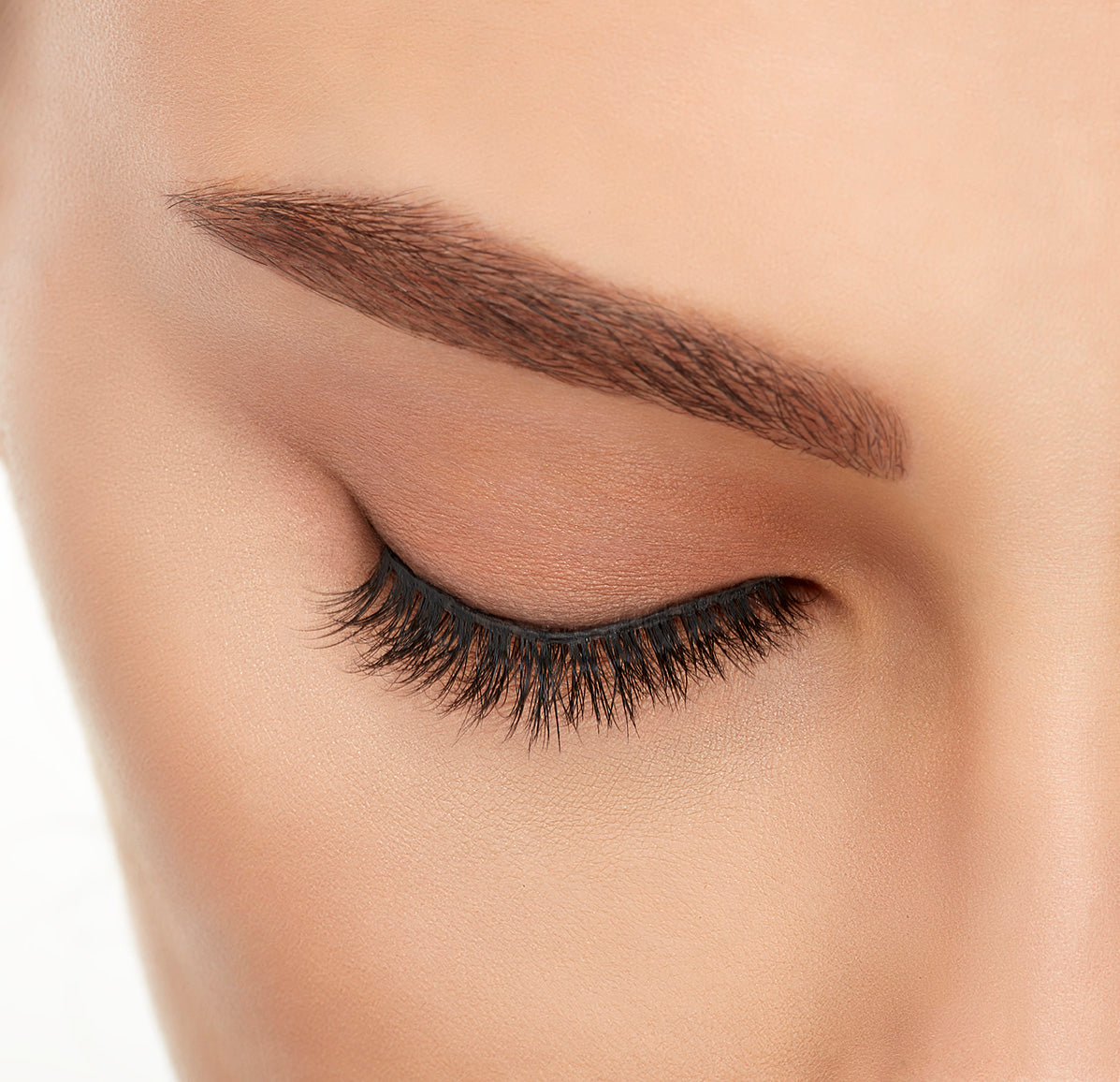 Close-up of a model's closed right eye wearing an Ardell Lift Effect 745 faux lash