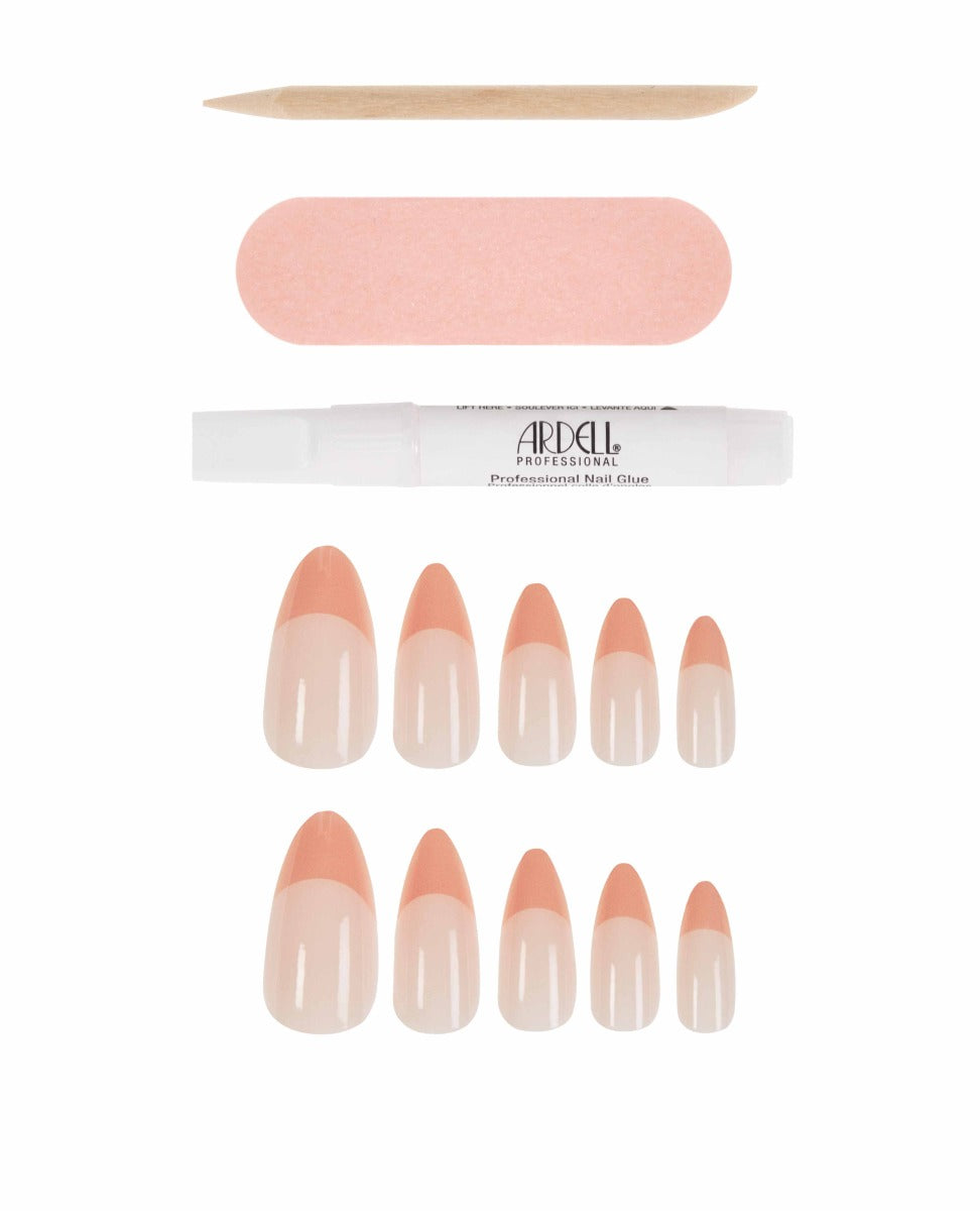 Nude almond press-on nails with coral French tips, perfect for a modern, elegant manicure.