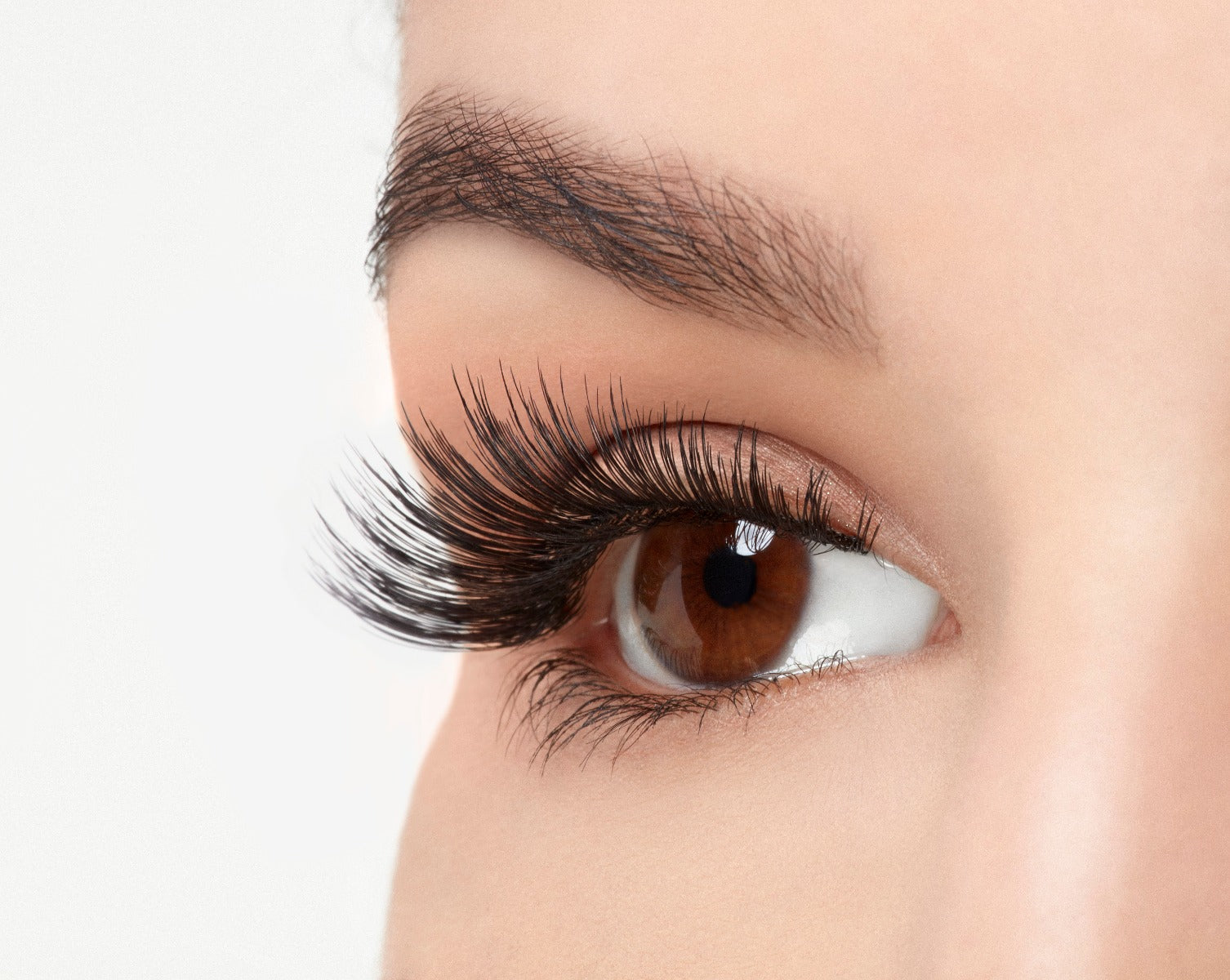 Angled close-up of a model's open right eye wearing an Ardell Soft Touch 152 faux lash
