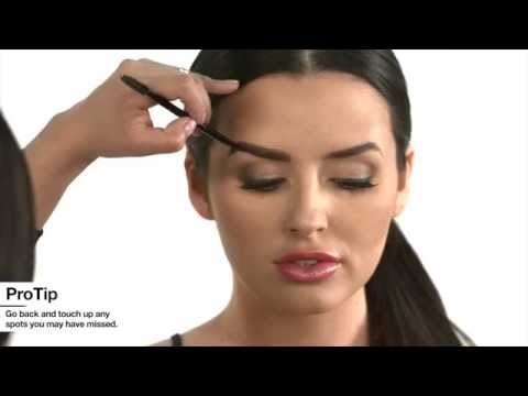 Makeup artist applying brow product for a defined, natural eyebrow look.