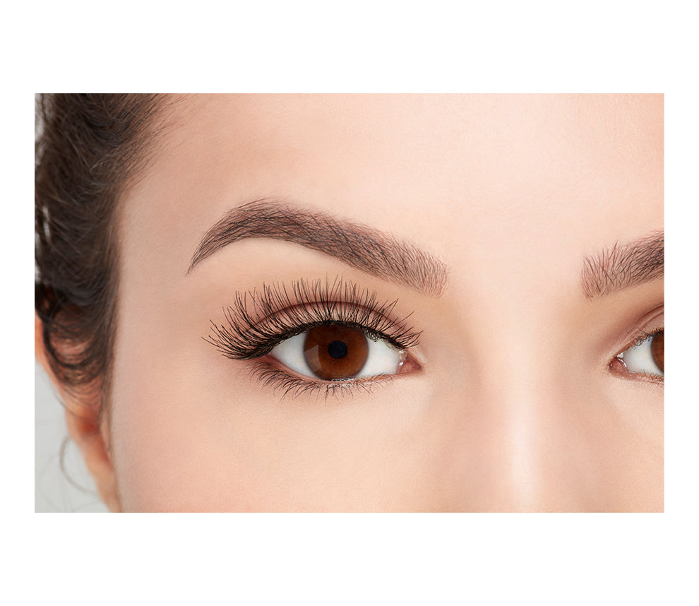 A model with an open right eye wearing Ardell Demi Wispies showing how it looks like when it's worn