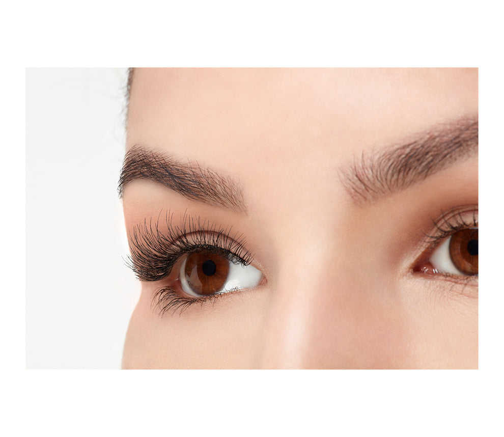 A model with an open right eye wearing Ardell Demi Wispies showing how it looks like when worn in a side view
