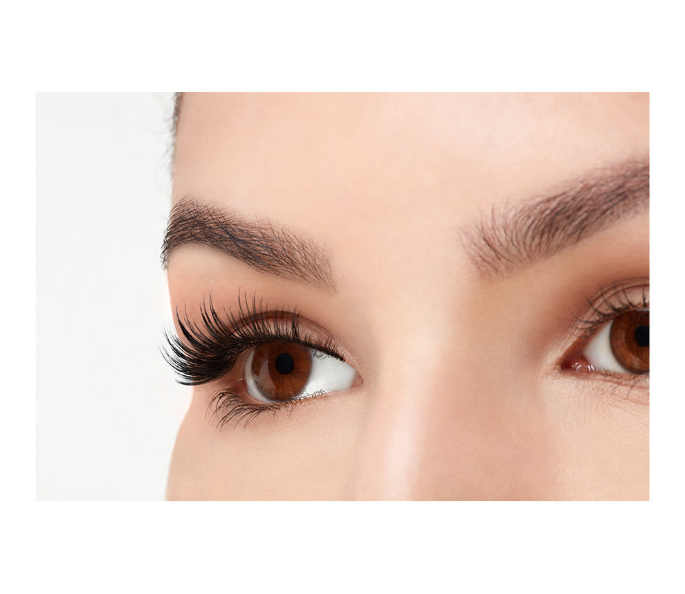 Angled close-up of a model's open right eye wearing an Ardell Faux Mink 810 faux lash