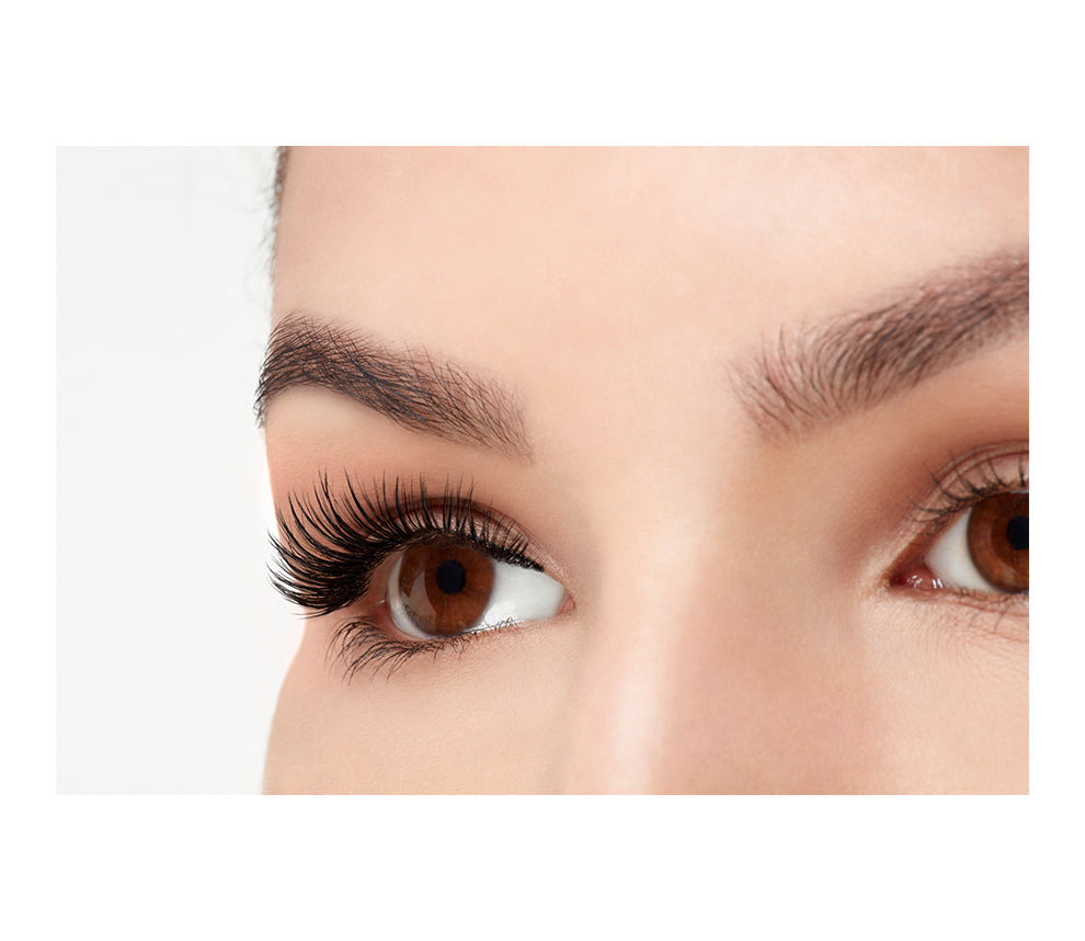 A model wearing  Ardell 3D Faux Mink Wispies in a side view emphasizing the curly, flared & natural lash look