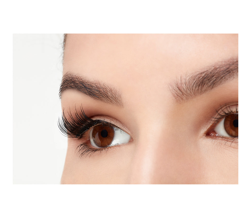 Angled close-up of a model's opened right eye wearing an Ardell Magnetic Accent 001 false lash.