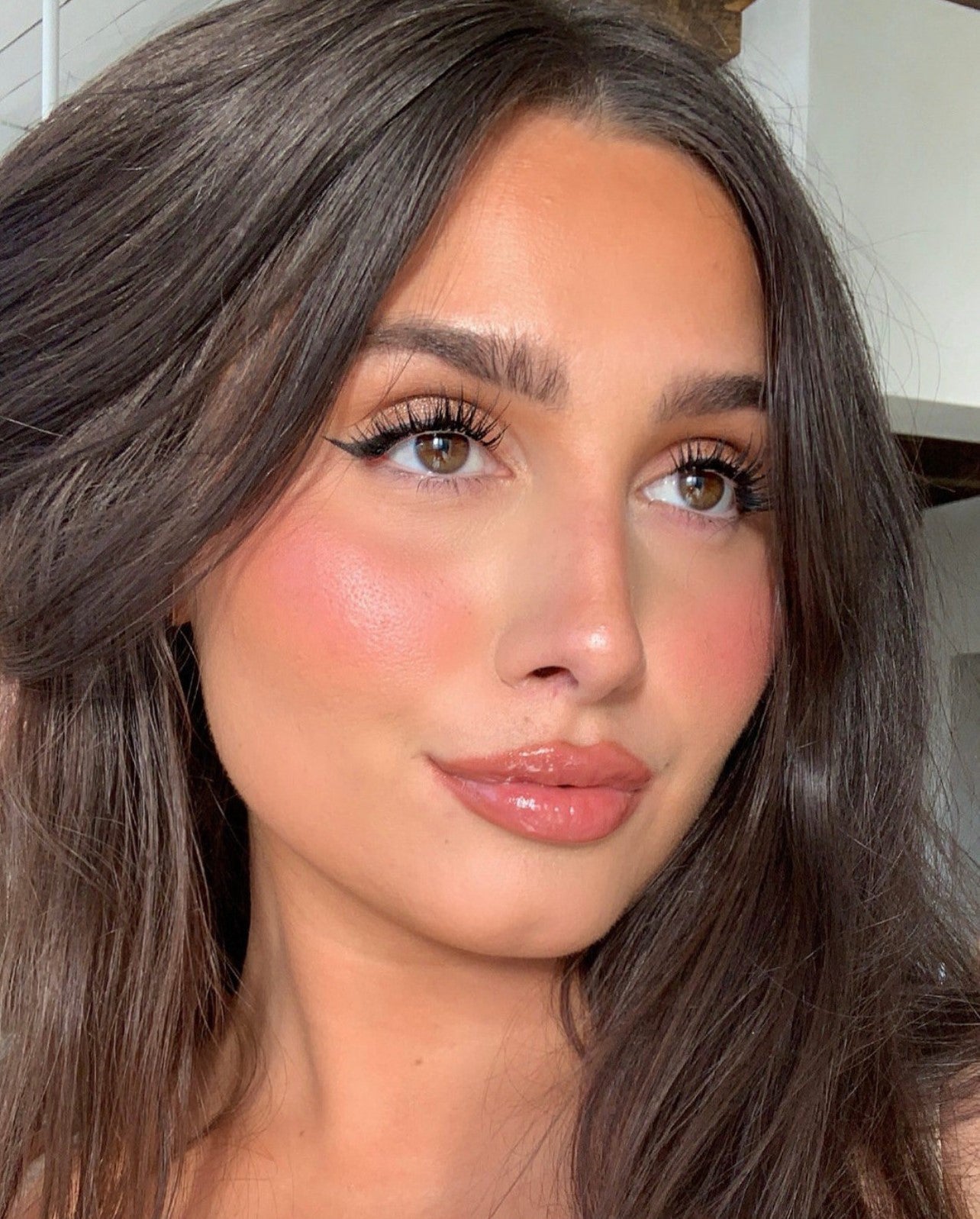 Close-up of model wearing Ardell lashes with a soft glam makeup look and voluminous lash finish.