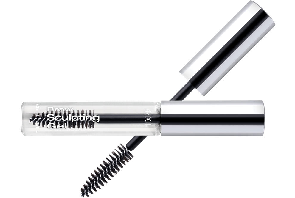 Capped bottle of Ardell Brow Sculpting Gel Clear laid on its side with brush cap featured on background