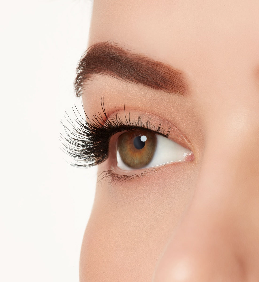 A close-up side shot of a model's eye wearing Ardell's Wispies 702 creating a natural, round light flared eyelash look