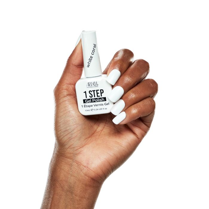 Fingertips painted in White Coral gel polish, featuring full coverage and a chic, clean white tone.