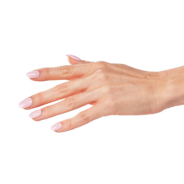 Close-up of Dahlia Dreams polish on model’s nails, showcasing its creamy light pink coverage and glossy finish.