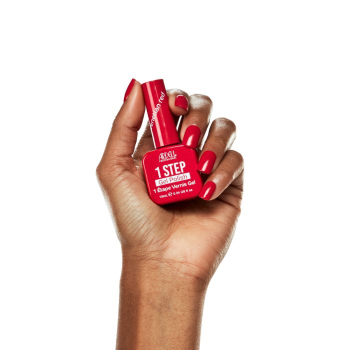 Hand model wearing Ardell Venetian Red polish, showcasing a bold crimson red gel manicure.