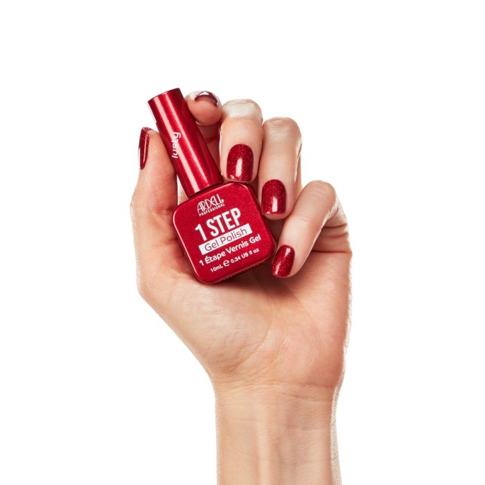 Hand model wearing Ardell Lusty polish, featuring a fiery red gel manicure with high-shine metallic shimmer.