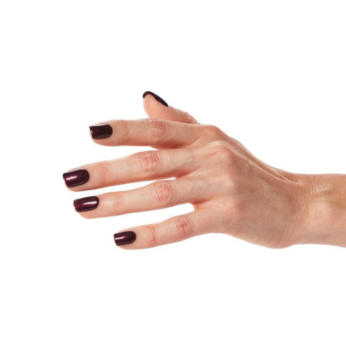 Close-up of hand wearing Ardell Candied Plum polish, a glamorous berry shade with reflective shimmer.