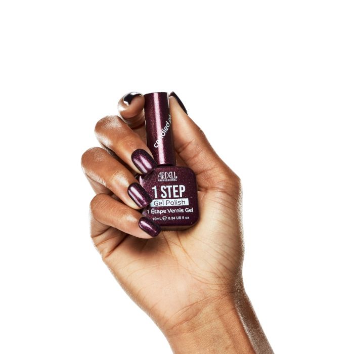 Model hand in Ardell Candied Plum polish, highlighting its glossy, jewel-toned plum finish.