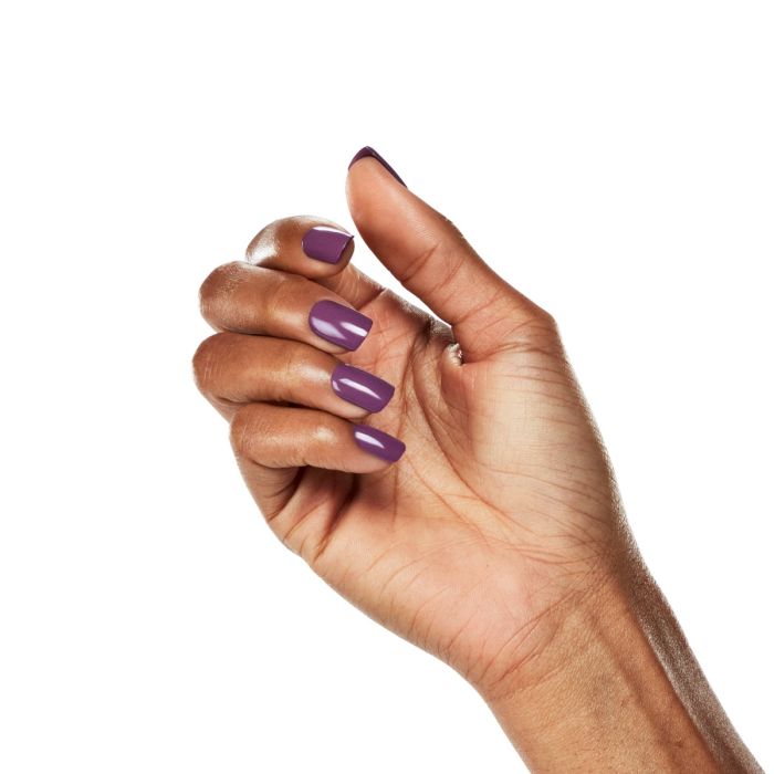 Natural hand pose with Ardell Plump Plum polish, a flattering purple shade perfect for year-round wear.