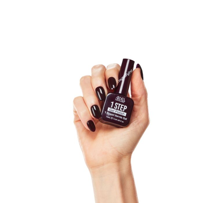 Hand model wearing Ardell Mystifying gel polish, showcasing a deep burgundy manicure with high-gloss shine.