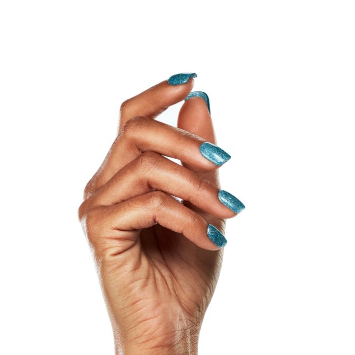 Model hand shot in Ardell Catching Waves gel polish, highlighting the electric turquoise-blue sparkle.