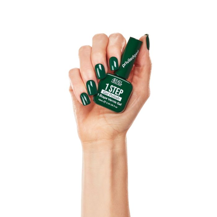 Hand model wearing Ardell Privileged gel polish, showing a bold and glossy dark green manicure.