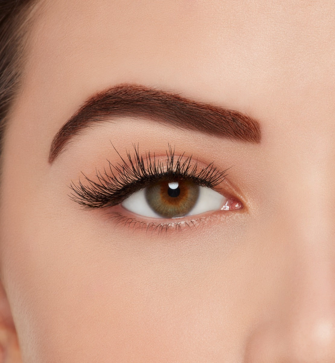 A model wearing  Ardell Naked Lashes 429 featuring a flirty flair, with a slight cluster effect and a round silhouette