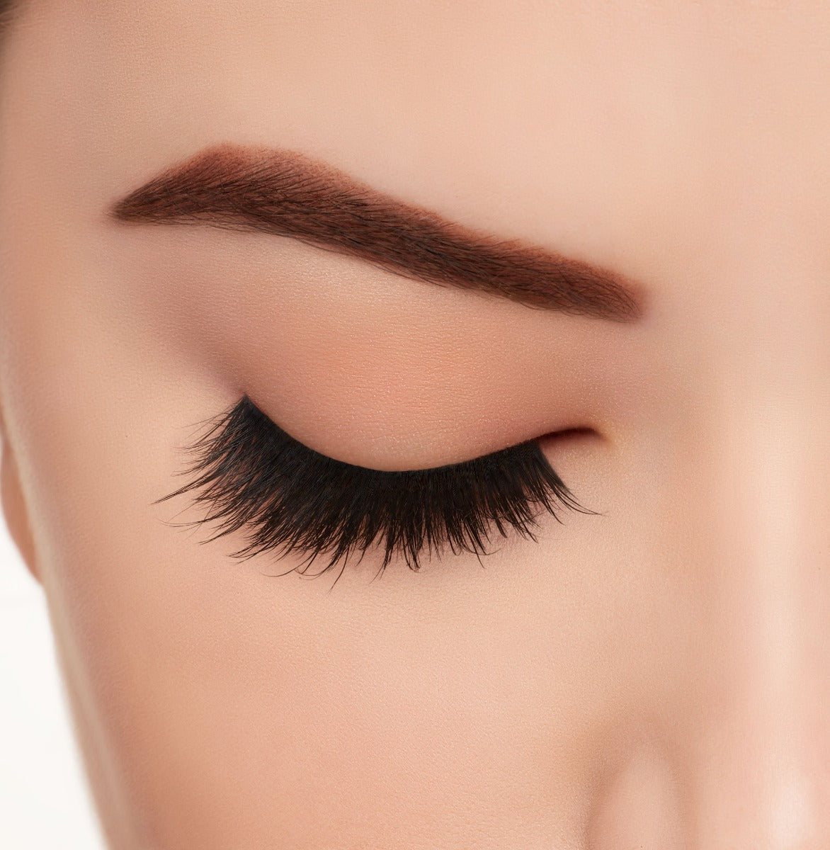 A model's closed right eye wearing Ardell Mega Volume 261 false lashes