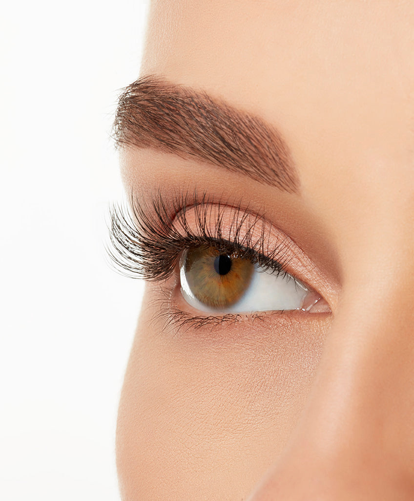 Angled shot of a model's open right eye wearing an Ardell Lift Effect 740 faux lash showing its light volume & medium length