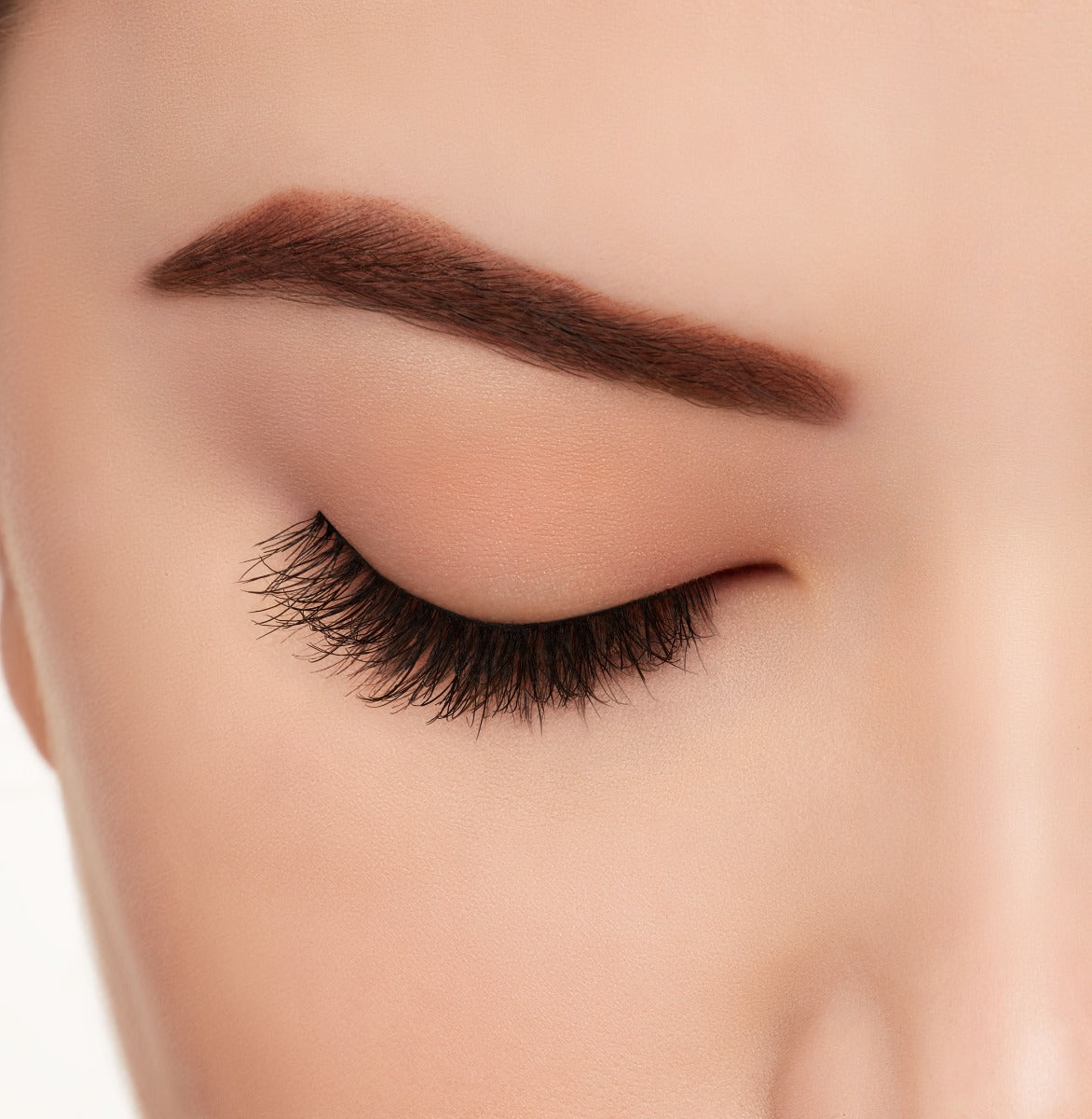 A model wearing Ardell's Ecolashes 451 with close right eye showing its extra-long layers with intense volume & fullness lash