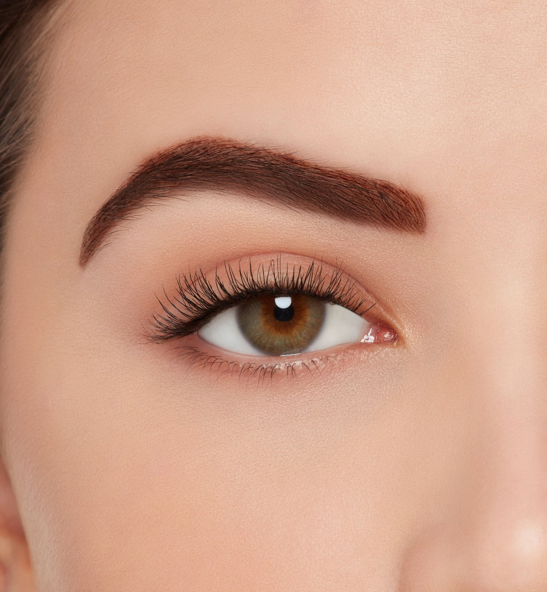 A model wearing Ardell's Ecolashes 455 to show the extra-long medium volume lash fibers and full look