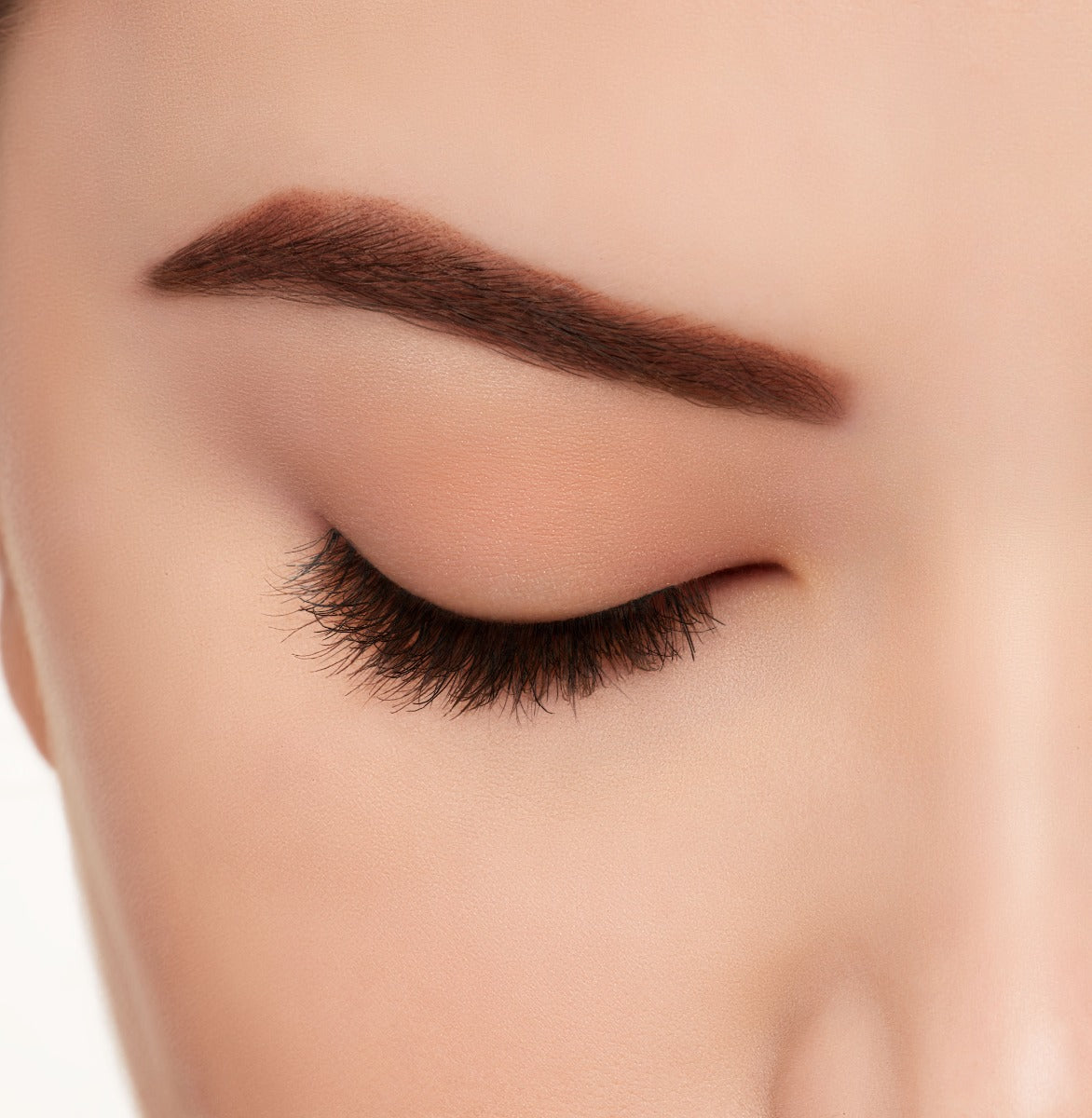 Ardell's Ecolashes 455 on a closed right eye to show its extra-long, intense volume full lash look. 